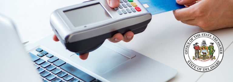 a person inserting a credit card into a payment device