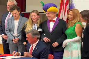 Gov. Carney signs proclamation for "Teach Children to Save Day."