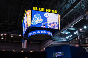 UD Basketball scoreboard showing DE529 logo